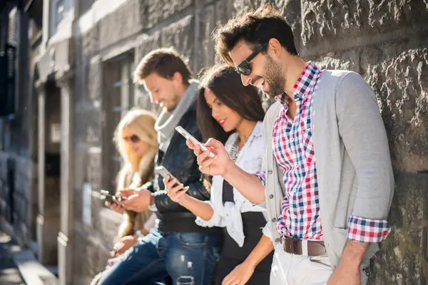 People using smartphones to engage with social media